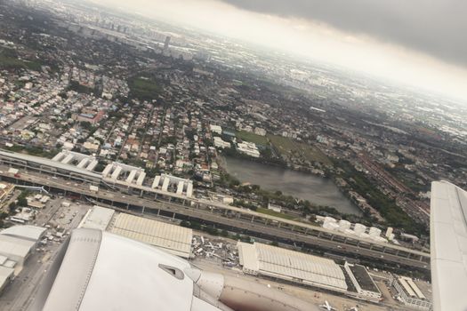 Flight and view over Bangkok in Thailand with nice city panorama from the airplane.