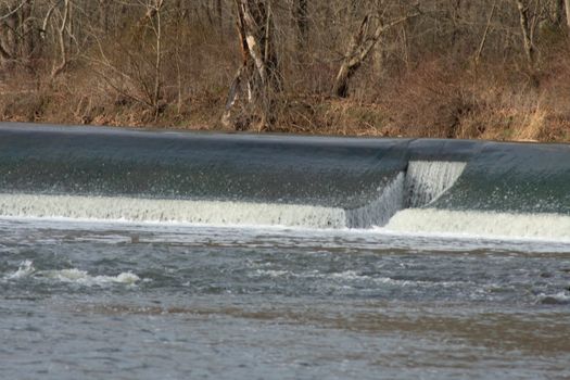 A Fast Flowing Man-Made Dam in a Dead Winter Forest