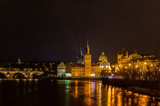Beautiful night view of the light illuminated Charles Bridge over Vltava River and the Bedrich Smetana Museum in the center of old town of Prague, Czech Republic