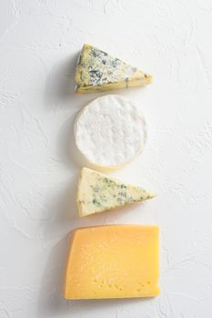 yellow parmesan, white Camembert and blue cheese Dor Blue on white background. Copy space. Concept serving cheese. Top view text space for you.