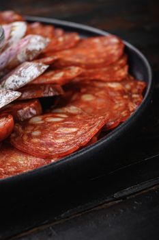 Spanish cold meat plate, chorizo, fuet, lomo,longaniza and salchichon on wooden table.