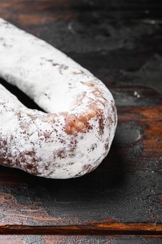 Dry cured fuet wurst on wooden surface.