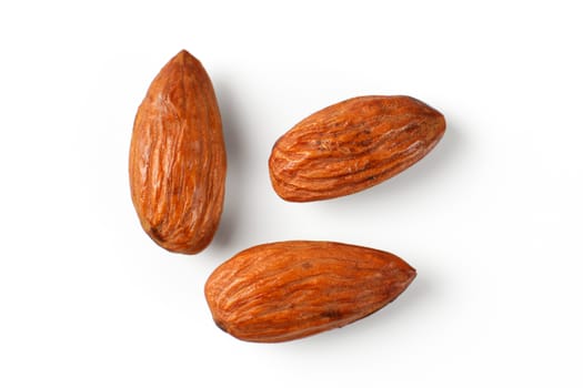 Top view on three almond nuts isolated on white background.