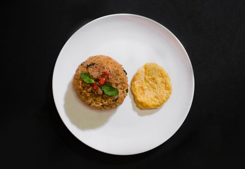 Basil pork fried rice and omelet egg on black background, Thai food, Street food, Image from the top view