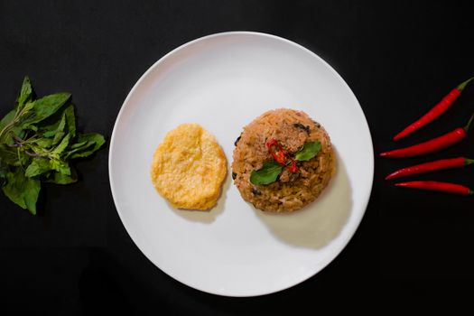 Basil pork fried rice and omelet egg on black background, Thai food, Street food, Image from the top view