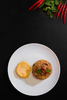 Basil pork fried rice and omelet egg on black background, Thai food, Street food, Image from the top view