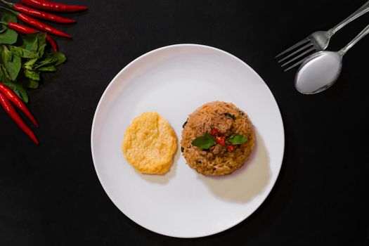 Basil pork fried rice and omelet egg on black background, Thai food, Street food, Image from the top view