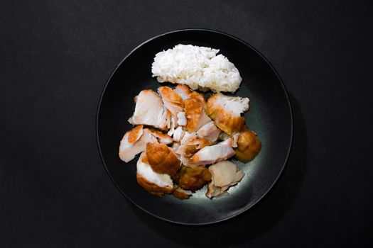 Fried chicken with sticky rice on dish on a black background, Image from the top view