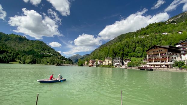 ALLEGHE, ITALY - AUGUST 2020: Boat on the beautiful lake in summer season.