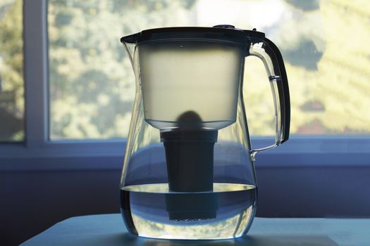 household water purifier on a window background.