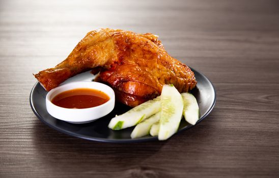 roasted chicken and vegetables on wooden table