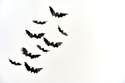 Halloween decoration concept black paper bats white cardboard background With copy space for tetxt