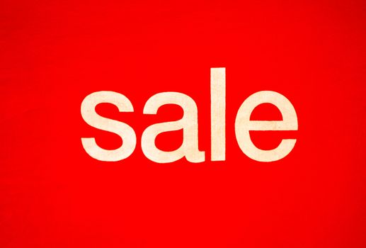 Photos of Red Discount Sign In a shopping mall. A red billboard printed the word "sale" on the fabric..