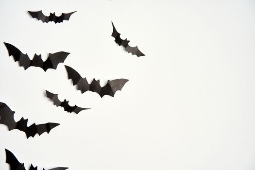 Halloween decoration concept black paper bats white cardboard background With copy space for tetxt
