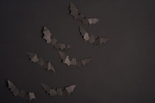 Halloween decoration concept black paper bats black cardboard background With copy space for tetxt