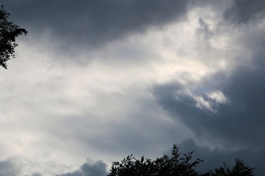 Dramatic sky before the storm with few branches on the edge of the picture