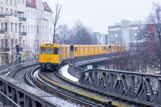 Berlin, Germany, February 2013: Berlin u-bahn or metro car making it's way through the winter snow on elevated railroad track