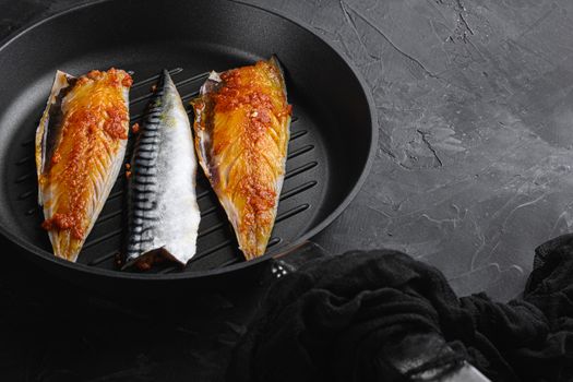 Marinated mackerel on pan on black background with space for text.