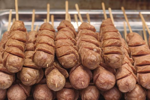 Street food asia. Sausages on a stick.