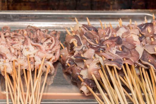 Street food asia. Squid on a stick.