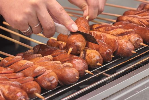 Street food asia. Sausages on a stick. Chinese street food