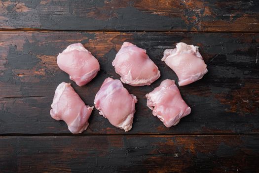 Organic skinless chicken thighs on wooden tabletop viewwith space for text.