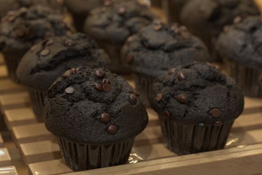 Chocolate cupcakes. Black cupcakes on a pallet