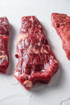 Alternative machete fajita steak organic meat cut side view close up over white concrete background vertical selective focus.