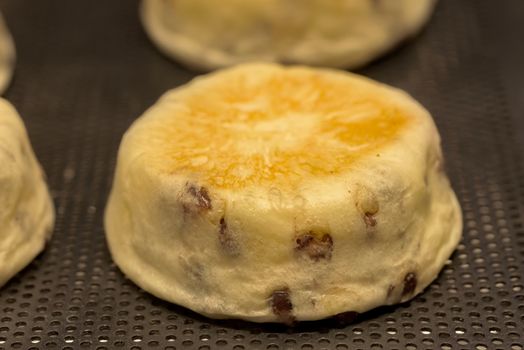 Homemade bun with raisins. Buns on the counter