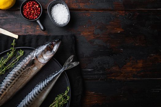 Raw whole sea fish with ingredients on wooden table, flat lay with space for text.
