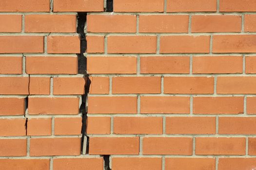 Cracked brick wall. Broken brick wall background