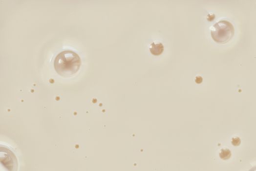 Condensed milk close-up. Background of condensed milk with bubbles
