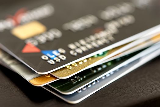 Credit card close-up. Plastic card on black background