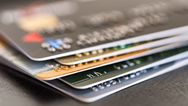 Credit card close-up. Credit card pile. Plastic card on black background