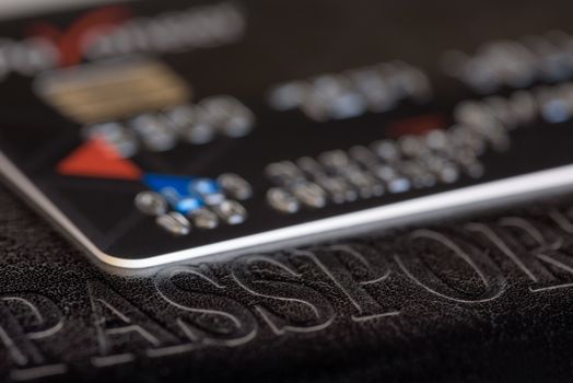 Credit card close-up. Plastic card on black background