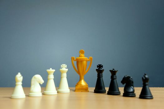 Golden trophy in the middle of chess pawn