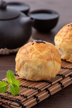 Moon cake yolk pastry, mooncake for Mid-Autumn Festival holiday, close up design concept on dark wooden table background