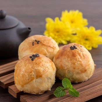 Moon cake yolk pastry, mooncake for Mid-Autumn Festival holiday, close up design concept on dark wooden table background