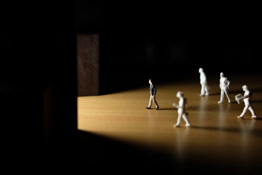 Business conceptual photo – Selective focus, miniature of businessman entering office building