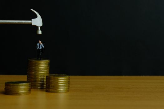 Miniature people concept - businessman stress thinking about financial crisis (toys photography )