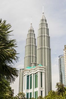 Amazing Petronas Twin Towers highest skyscrapers in Kuala Lumpur, Malaysia. Between palms view.