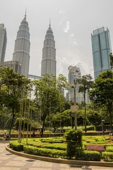 KLCC Park and Petronas Twin Towers in the city centre of Kuala Lumpur, Malaysia.