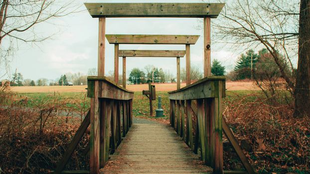 An Old Wooden Bridge Crossing a Small Creek in an Autumn Forest