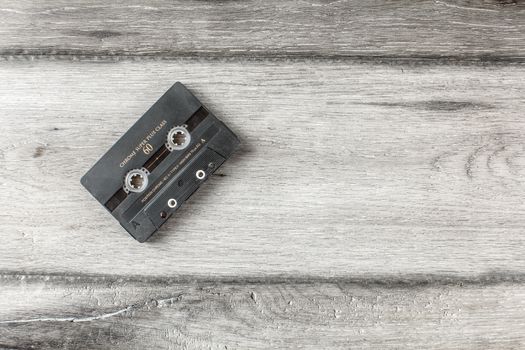 Liptovsky Hradok, Slovakia - March 10, 2018: Table top view on old mixtape cassette on gray wooden desk.