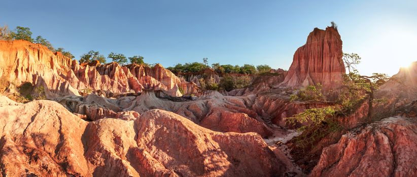 High resolution panorama of Marafa Depression (Hell's Kitchen canyon) with red and yellow cliffs and rocks in afternoon sunset back light. Malindi, Kenya