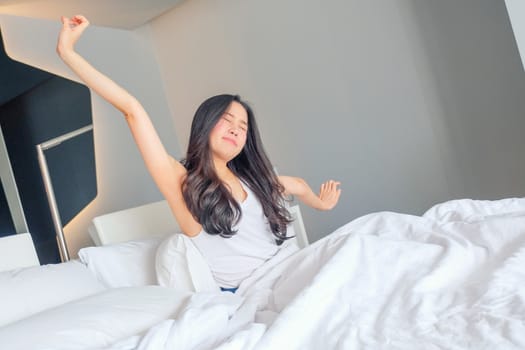 Woman stretch herself out after waking up in the morning