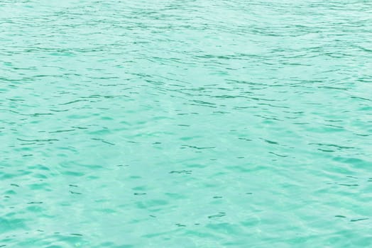 Turquoise water surface. Glare on the sea surface