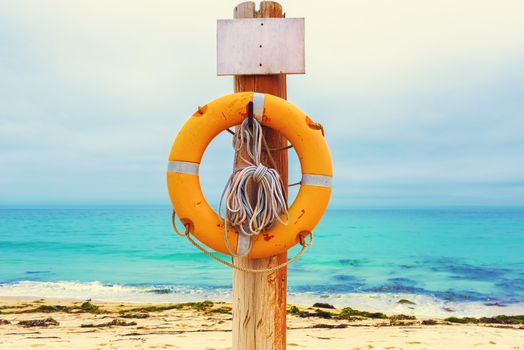 Lifebuoy on the beach. Concept of saving lives