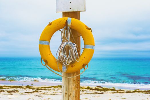 Lifebuoy on the beach. Concept of saving lives