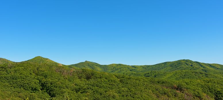 Summer mountains and blue sky landscape. Green mountains